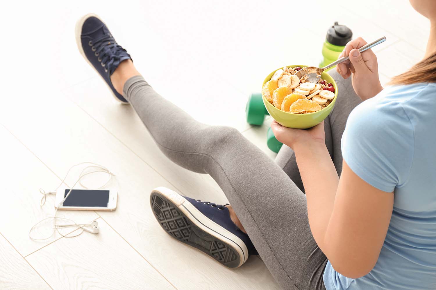 sitting on floor and eating porridge